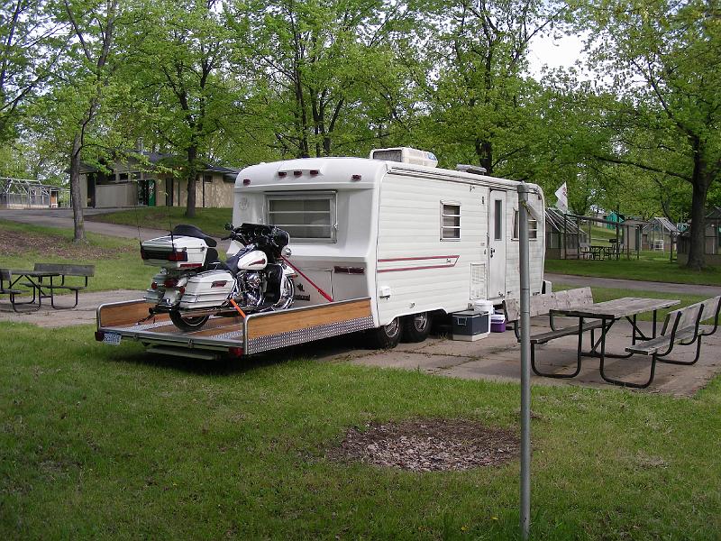 DSCN2620.JPG - They wanted a toy hauler. So this couple got this trailer free last year during the last rally.  They removed the rear bedroom because of rot, but kept the frame.  They use the resulting platform to travel with their cycle. The result, a toy hauler for for $900 and a lot of their time.