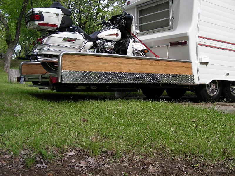 DSCN2621.JPG - They wanted a toy hauler. So this couple got this trailer free last year during the last rally.  They removed the rear bedroom because of rot, but kept the frame.  They use the resulting platform to travel with their cycle. The result, a toy hauler for for $900 and a lot of their time.