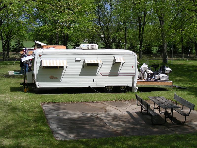 DSCN2867.JPG - They wanted a toy hauler. So this couple got this trailer free last year during the last rally.  They removed the rear bedroom because of rot, but kept the frame.  They use the resulting platform to travel with their cycle. The result, a toy hauler for for $900 and a lot of their time.